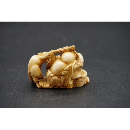 1249 - A good Japanese carved ivory netsuke, 19th century, depicting a man with a rat, signed, 4.6cm wide.... 