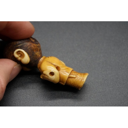 1250 - An unusual Japanese carved ivory netsuke, Meiji, depicting a standing monkey in robes, with inset ey... 