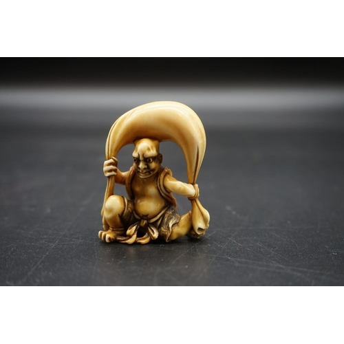 1251 - A good Japanese carved ivory netsuke, 19th century, depicting Fujin with his bag of wind, 4.5cm high... 