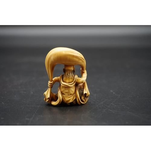 1251 - A good Japanese carved ivory netsuke, 19th century, depicting Fujin with his bag of wind, 4.5cm high... 