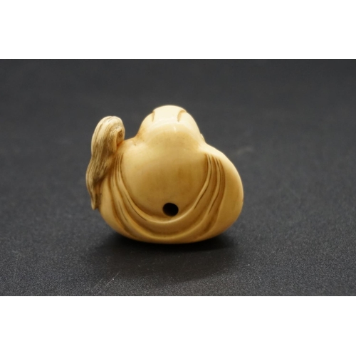 1254 - A good Japanese carved ivory netsuke, by Masahiro, Edo, depicting Daruma wall-gazing, with inset eye... 