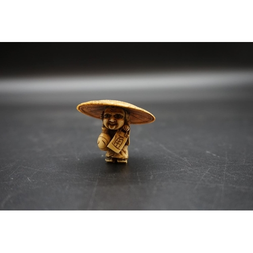 1255 - A good Japanese carved ivory okimono, Meiji, possibly depicting Shoki, 3.4cm high x 4cm wide.... 