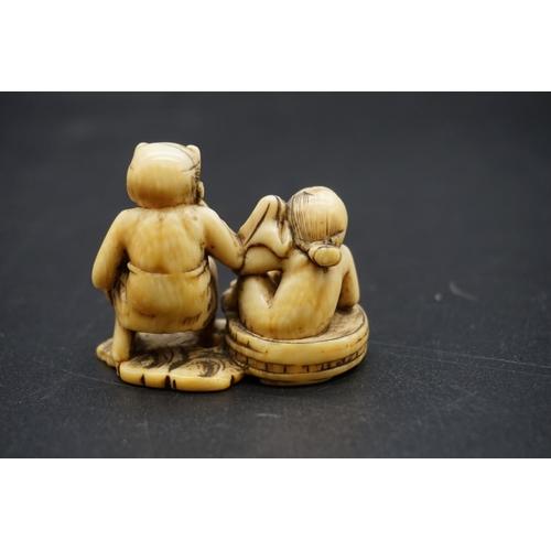 1257 - A good Japanese carved ivory netsuke, Edo, depicting Raijin and Okame in a bathtub, 4.5cm wide.... 