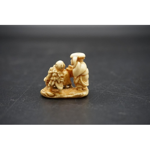 1263 - An unusual Japanese carved ivory netsuke, probably Edo, depicting a cow like woman, with man and chi... 