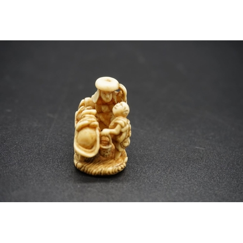 1263 - An unusual Japanese carved ivory netsuke, probably Edo, depicting a cow like woman, with man and chi... 