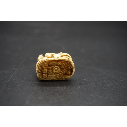 1263 - An unusual Japanese carved ivory netsuke, probably Edo, depicting a cow like woman, with man and chi... 