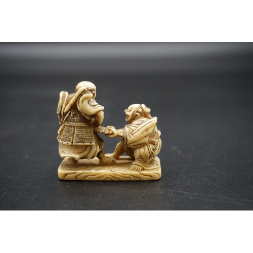 1270 - A good Japanese carved walrus ivory netsuke, Edo, depicting two Samurai, 4.7cm wide.... 