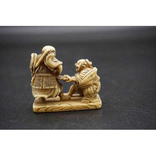 1270 - A good Japanese carved walrus ivory netsuke, Edo, depicting two Samurai, 4.7cm wide.... 