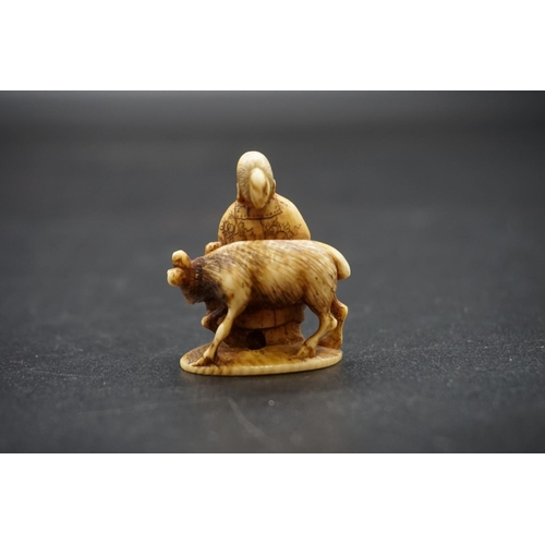 1275 - A Japanese carved ivory netsuke, 19th century, depicting a man and a deer, signed, 3.4cm high.... 