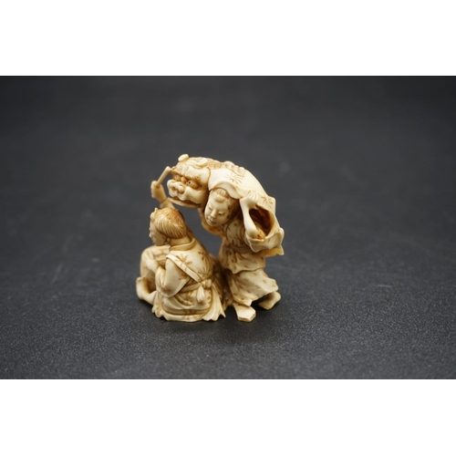 1276 - A good Japanese carved ivory netsuke, 19th century, depicting two figures with a tiger skin and drum... 