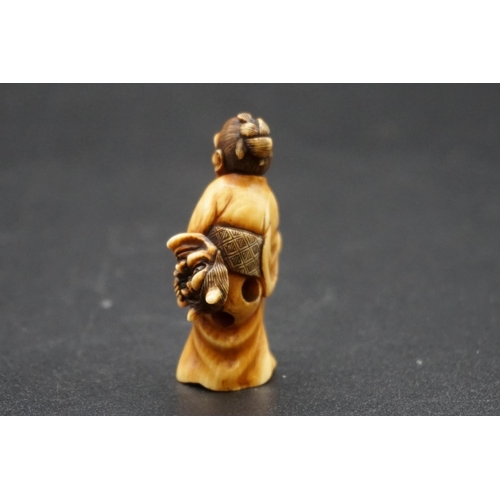 1278 - A good Japanese carved ivory netsuke, Meiji, depicting an elderly lady with a Noh mask and stick, 4.... 