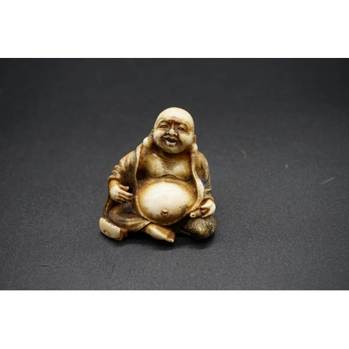 1279 - A Japanese carved ivory netsuke of Hotei, Meiji, signed, 3.7cm high.