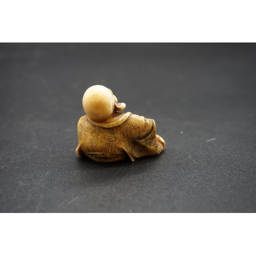 1279 - A Japanese carved ivory netsuke of Hotei, Meiji, signed, 3.7cm high.