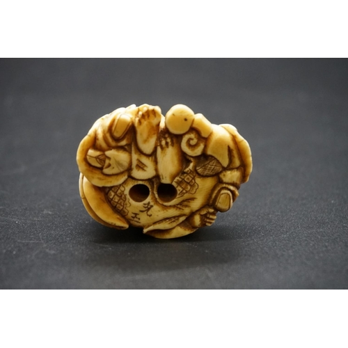 1280 - A good Japanese carved ivory netsuke, Edo, depicting Hotei and two Karako, signed, 4cm high.... 