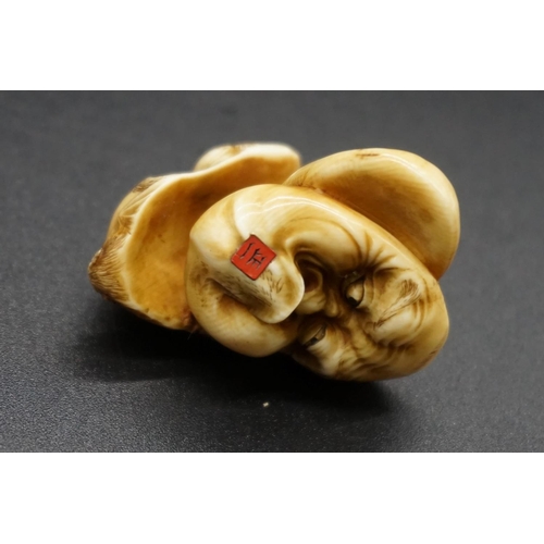 1281 - A good Japanese carved ivory netsuke of three masks, by Masakazu, Edo, signed on inset tablet, ... 