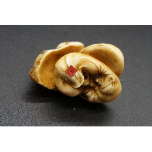 1281 - A good Japanese carved ivory netsuke of three masks, by Masakazu, Edo, signed on inset tablet, ... 