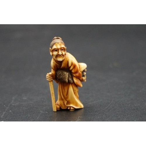 1278 - A good Japanese carved ivory netsuke, Meiji, depicting an elderly lady with a Noh mask and stick, 4.... 