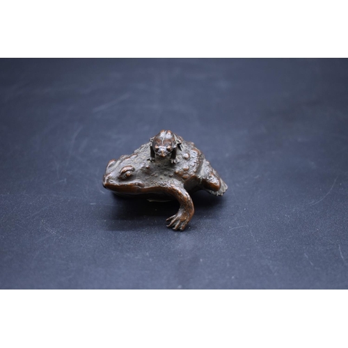 1287 - A Japanese bronze toad, with a smaller toad on its back, 8cm long.  