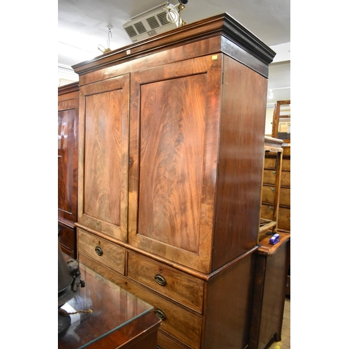 1435 - A George III figured mahogany linen press, the pair of panelled doors now enclosing hanging space, 1... 