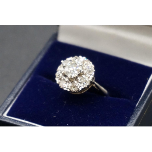 203 - An Edwardian diamond cluster ring, set to centre with a cushion shape old cut diamond of approx... 