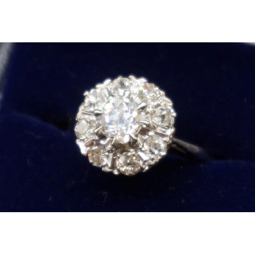 203 - An Edwardian diamond cluster ring, set to centre with a cushion shape old cut diamond of approx... 