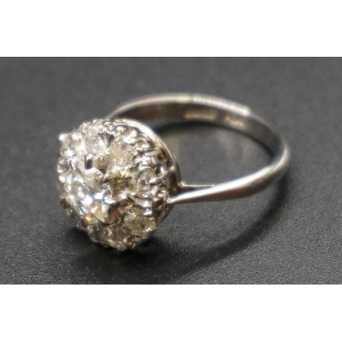 203 - An Edwardian diamond cluster ring, set to centre with a cushion shape old cut diamond of approx... 