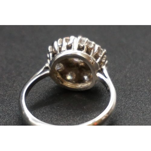 203 - An Edwardian diamond cluster ring, set to centre with a cushion shape old cut diamond of approx... 