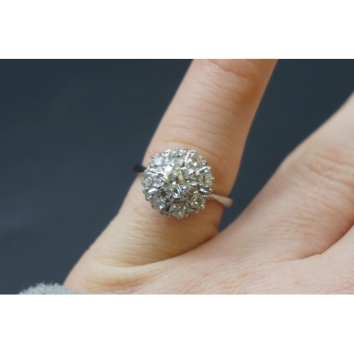 203 - An Edwardian diamond cluster ring, set to centre with a cushion shape old cut diamond of approx... 