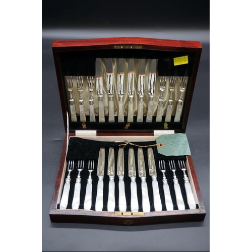 63 - A mahogany cased set of twelve pairs of silver and mother-of-pearl dessert knives and forks, by Harr... 