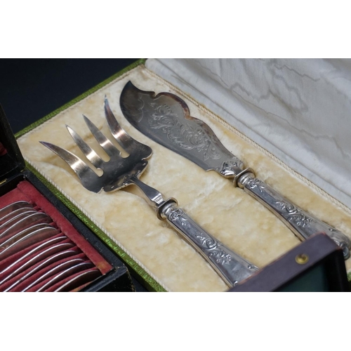 76 - A cased pair of French silver fish servers; together with a collection of French silver plated cutle... 