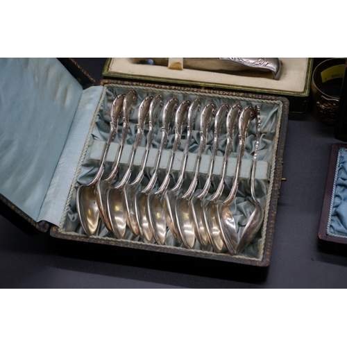 76 - A cased pair of French silver fish servers; together with a collection of French silver plated cutle... 