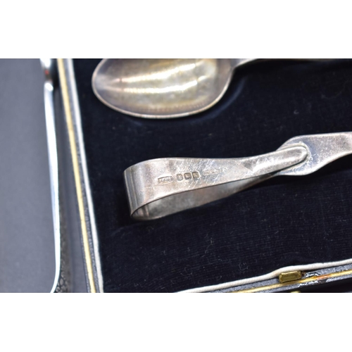 84 - A pair of Victorian silver sugar tongs, London 1888, together with a silver shell caddy spoon, Sheff... 