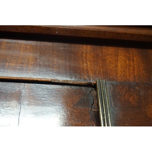 1436 - An early 19th century figured mahogany linen press, the pair of panelled doors enclosing four slidin... 