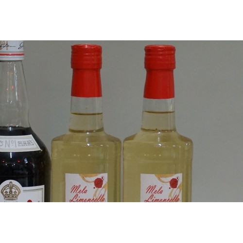 153 - A mixed group of spirits and liqueurs, comprising: two 70cl bottles of Mela Limoncella; a 50cl bottl... 