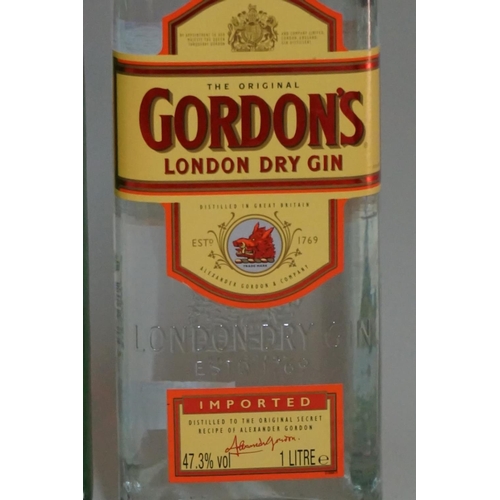 96 - An old 1.13 litre bottle of Gordon's London dry gin; together with another 1 litre bottle of Gordon'... 