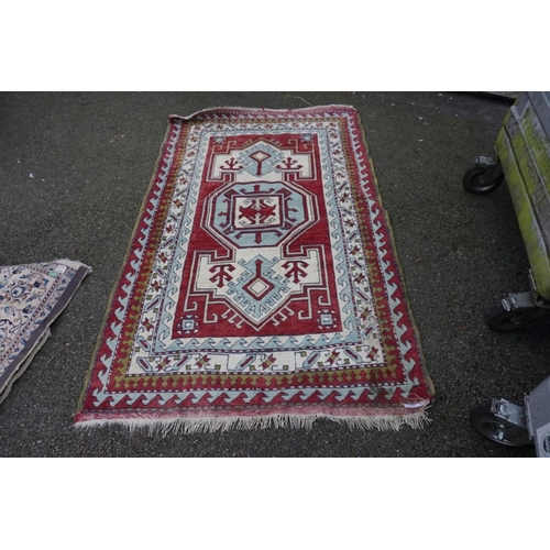 1062 - A Persian rug, having central medallion with geometric borders, 215cm x 135cm.