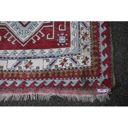 1062 - A Persian rug, having central medallion with geometric borders, 215cm x 135cm.