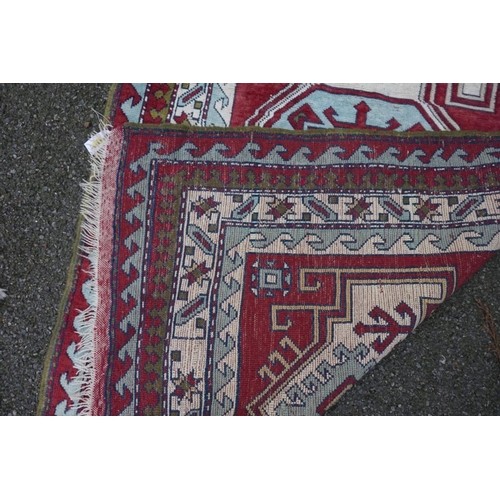 1062 - A Persian rug, having central medallion with geometric borders, 215cm x 135cm.