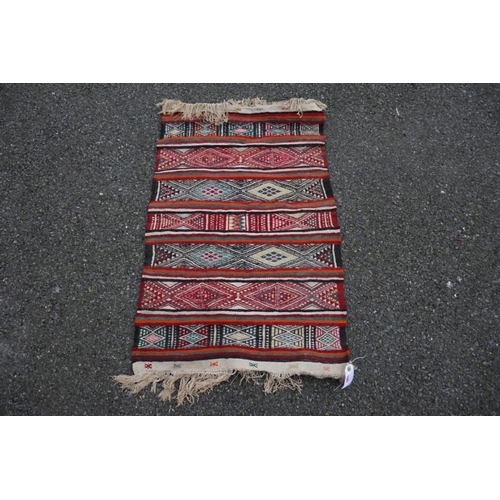 1067 - A small Caucasian rug, 93cm x 63cm. 