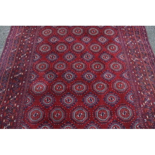 1069 - A Bokhara carpet, having repeated central field with geometric borders, 280cm x 208cm.... 