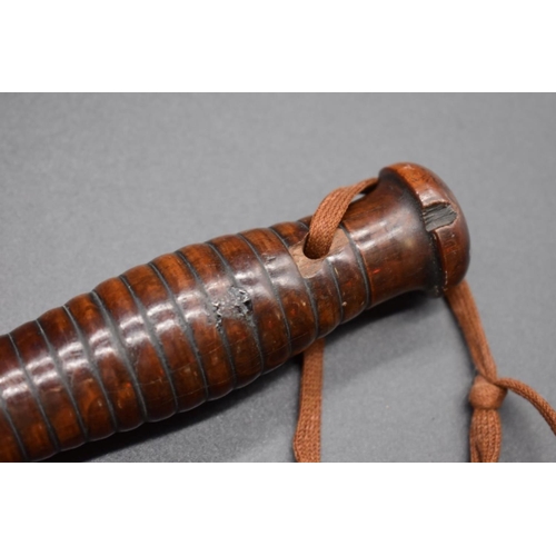 1715 - An antique truncheon, with ribbed handle, 40cm long. 