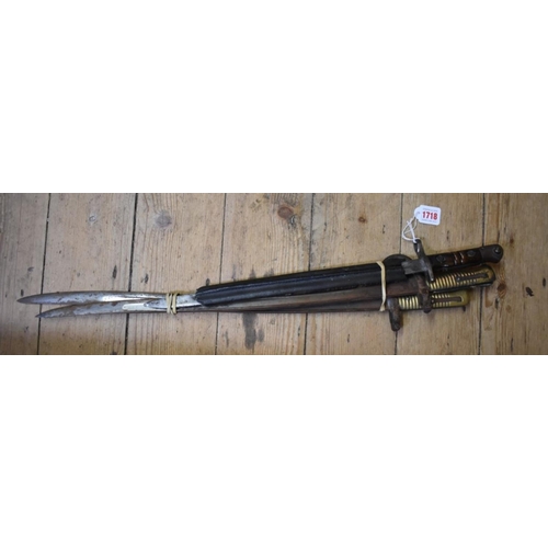 1718 - A World War I US M-1917 Enfield bayonet, stamped 1917 W, with incomplete leather scabbard; together ... 