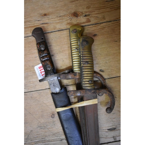 1718 - A World War I US M-1917 Enfield bayonet, stamped 1917 W, with incomplete leather scabbard; together ... 