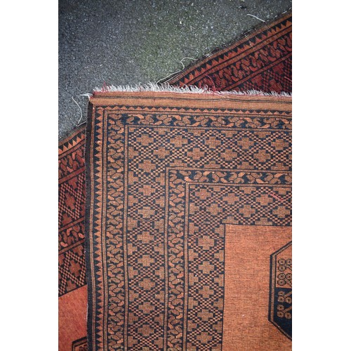 1065 - An Afghan rug, having four central medallions, 220cm x 152cm.