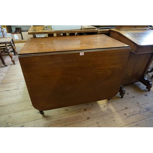 1058 - A Regency mahogany drop leaf dining table, on brass caps and casters, 168cm when open.... 