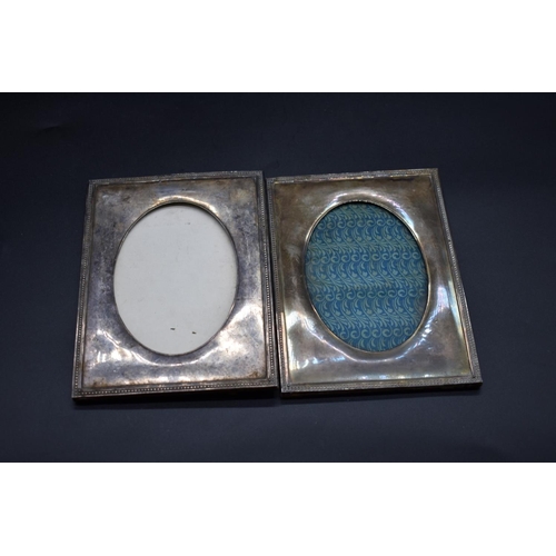 614 - A pair of metal photograph frames, having oval apertures and beaded borders, 18 x 13cm.... 