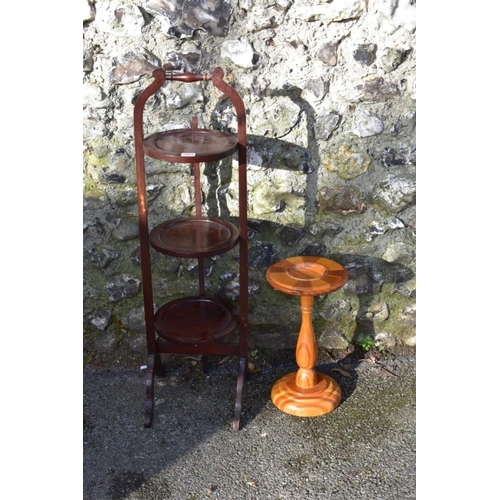 1059 - An antique mahogany cake stand; together with a New Zealand specimen wood torchere.