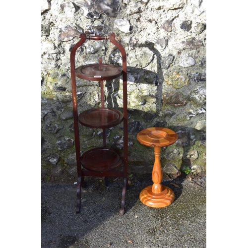 1059 - An antique mahogany cake stand; together with a New Zealand specimen wood torchere.