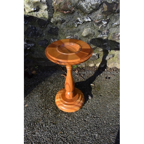 1059 - An antique mahogany cake stand; together with a New Zealand specimen wood torchere.