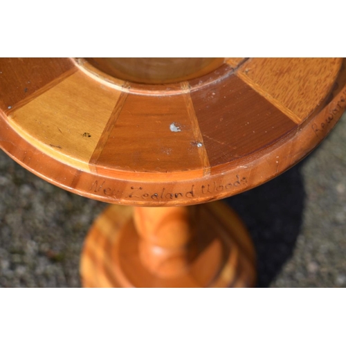 1059 - An antique mahogany cake stand; together with a New Zealand specimen wood torchere.